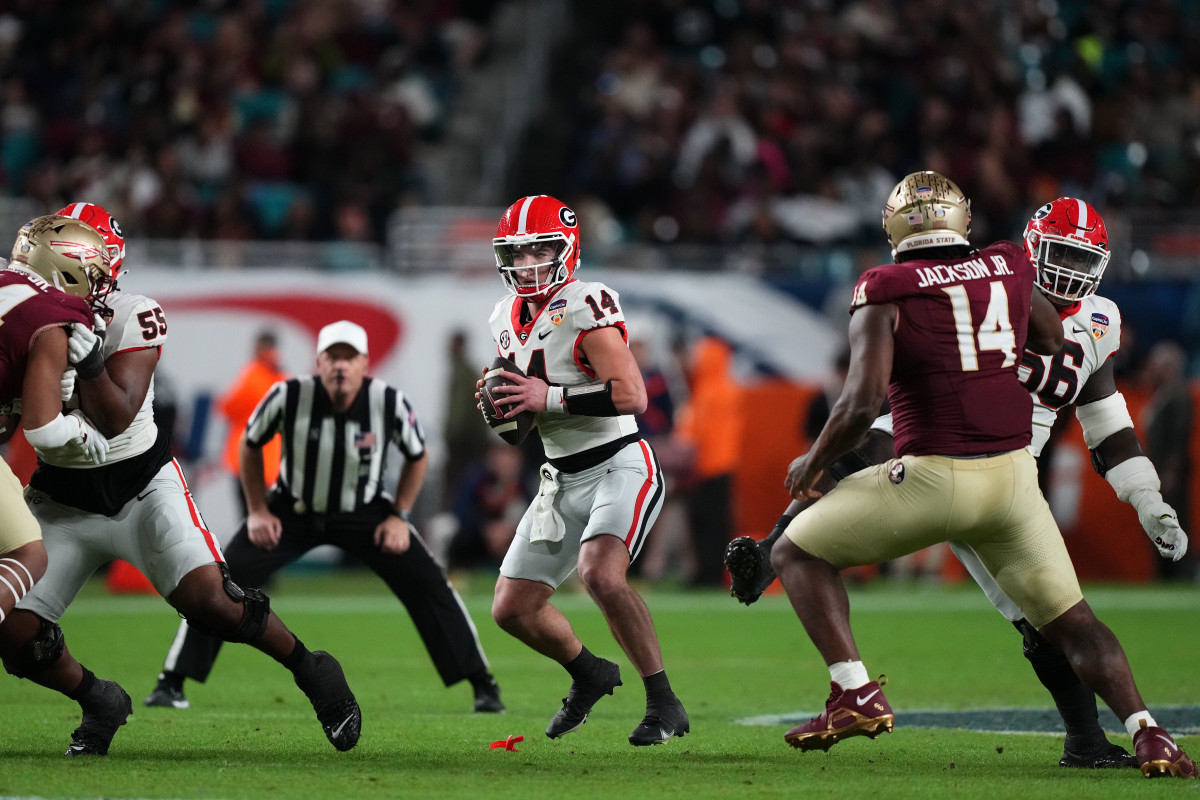 Dec 30, 2023; Miami Gardens, FL, USA; Georgia Bulldogs quarterback Gunner Stockton (14) drops back to pass Florida State Seminoles during the second half in the 2023 Orange Bowl at Hard Rock Stadium.© Jasen Vinlove-USA TODAY Sports